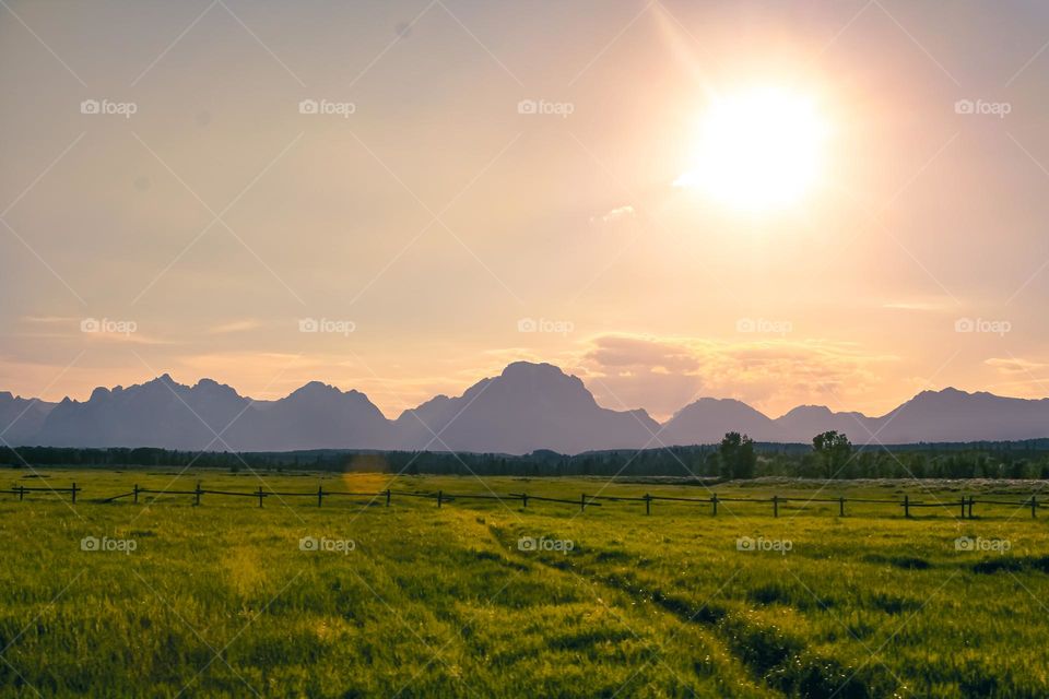 Wyoming Teton national park prairie farmland field rural area scenic view mountain range wooden fence sunrise morning evening sunset mother nature countryside sun sunny saturation vibrant colorful warm tones contrast off grid landscape beautiful 