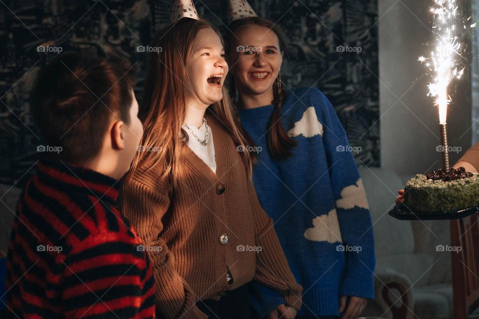 Surprised teenager girl celebrating birthday surprised by cool presents