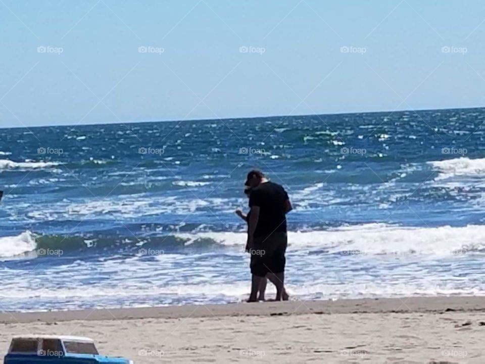 Father/daughter at the beach on a beautiful day