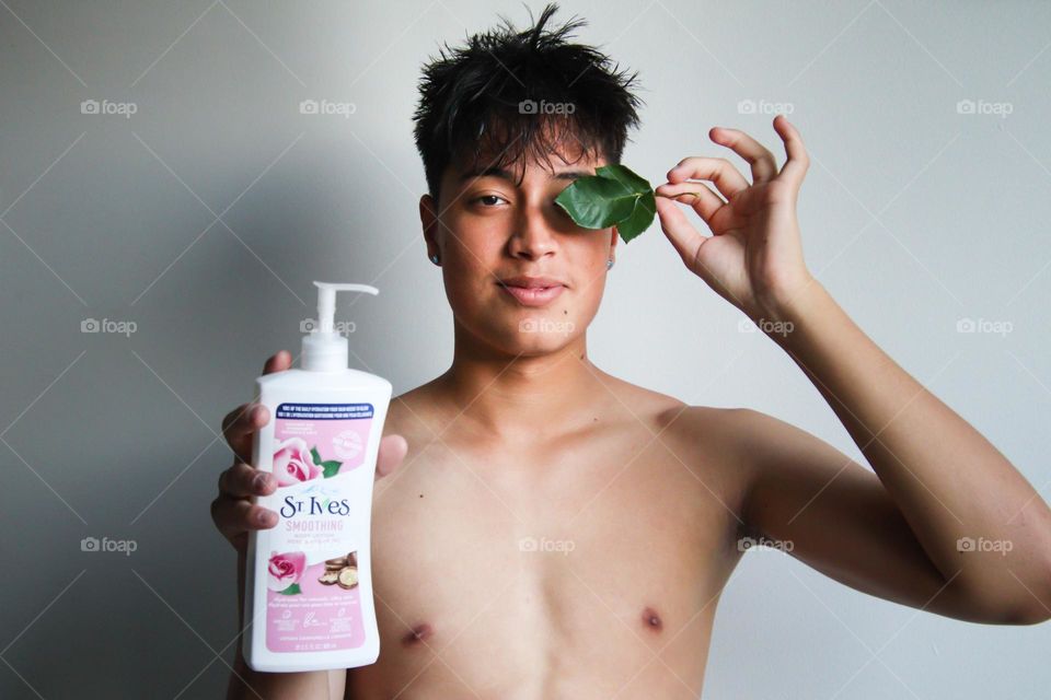 Young man is holding St.Ives body lotion