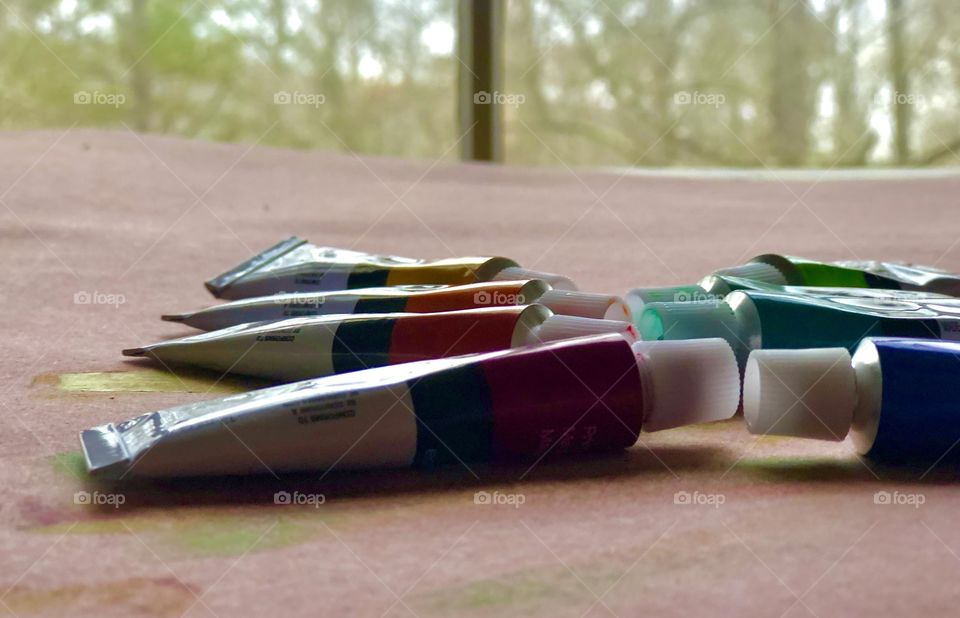 Paint set on drafting table by window 