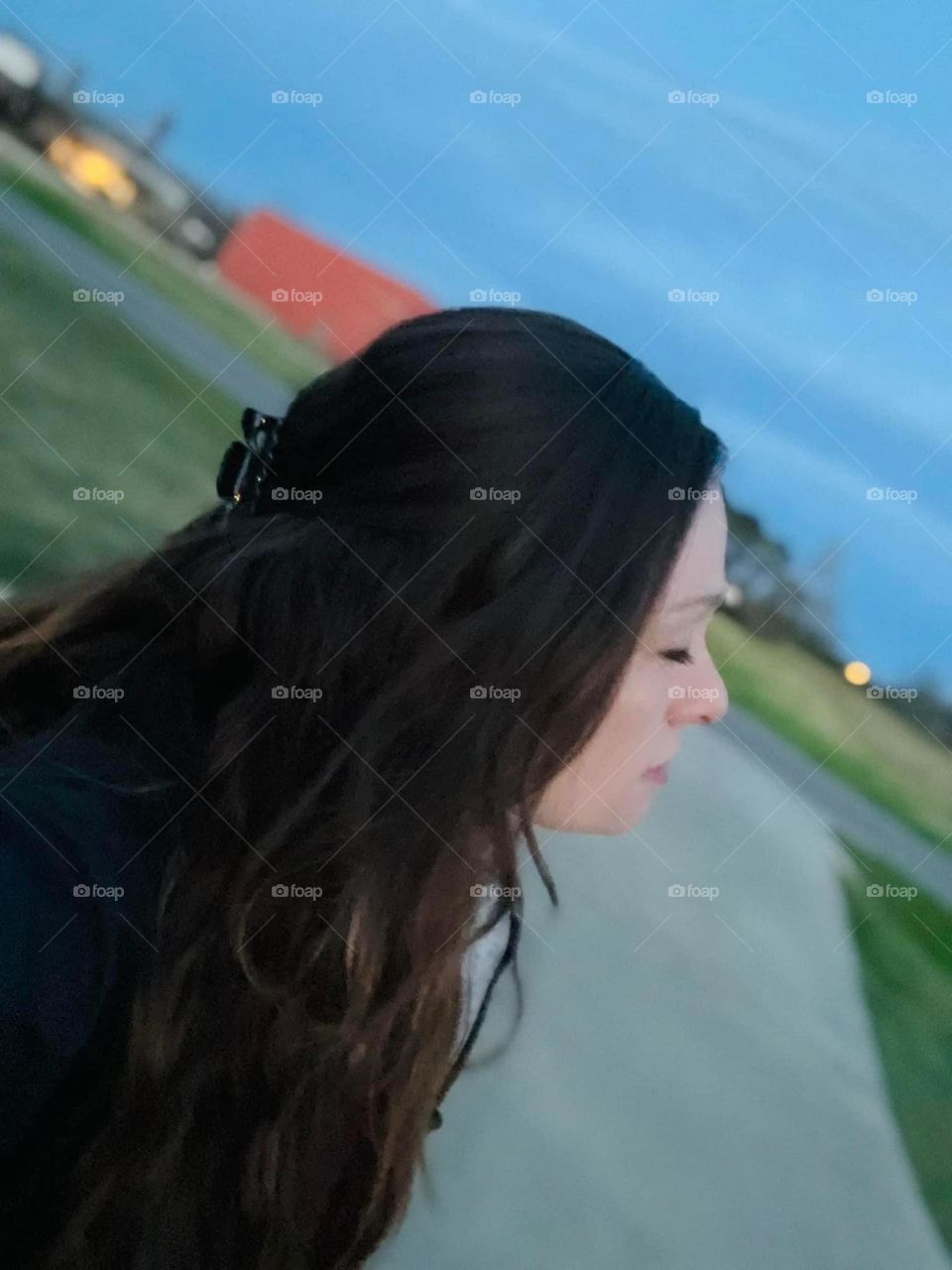 A woman outside, early morning, taking a deep breath . 