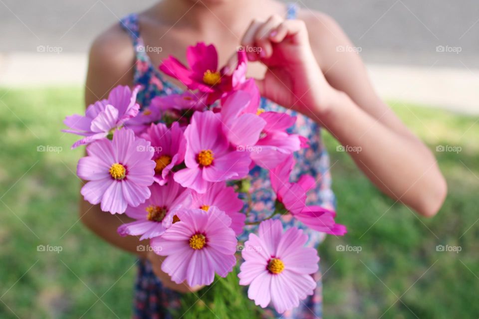 Holding bunch of flowers 