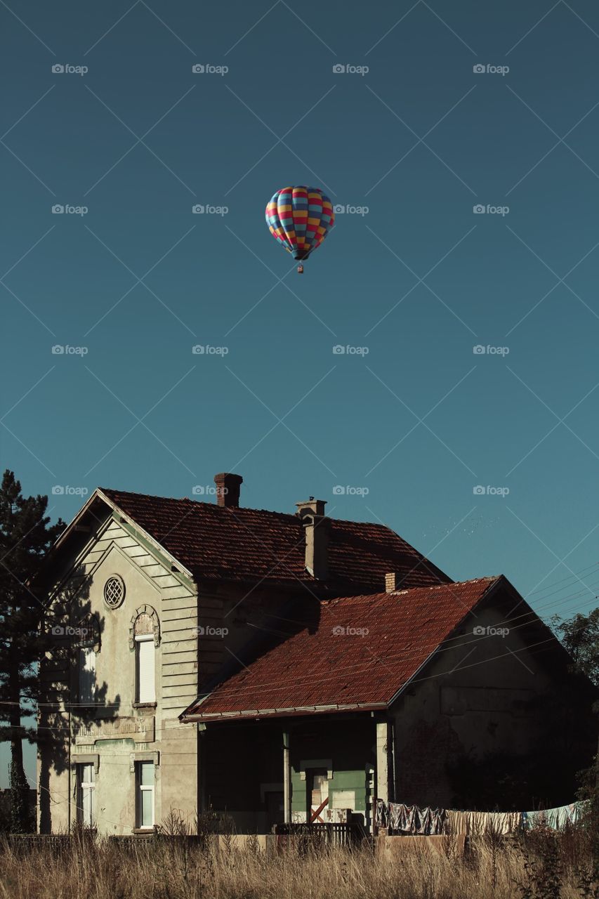 Abandoned old house & hot air balloon on sky