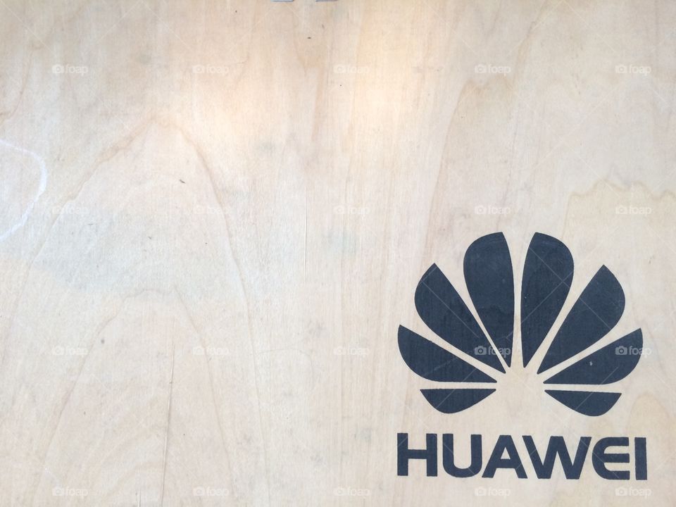 Huawei logo on the wooden board. 