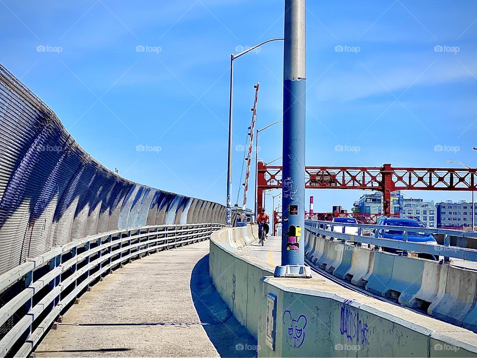 The “Pulaski Bridge” is raising the red & white striped barrier that goes down when the bridge is opened to let tall ships through. It is raised to signal to all commuters that the bridge is open for traffic again. 2022. Hypnotic Productions