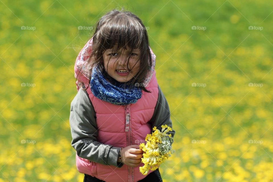 Child with yellow flowers 