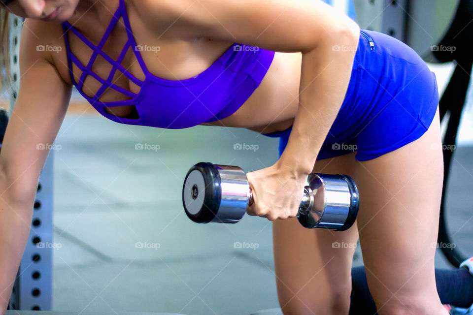 a woman with dumbbell