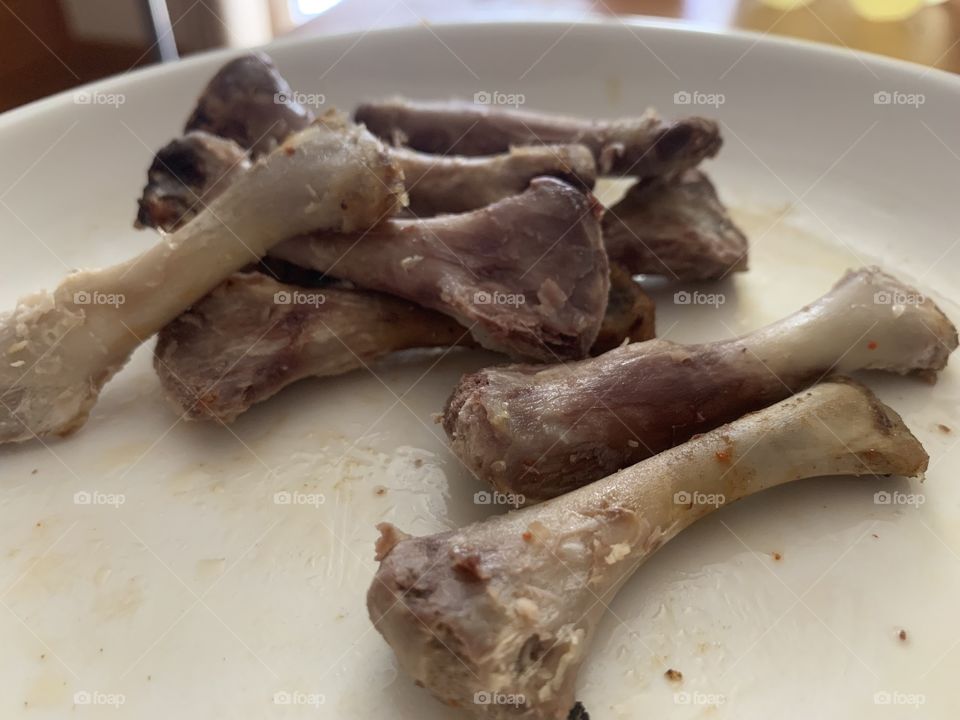 Chicken bones in plate. Hungry eating