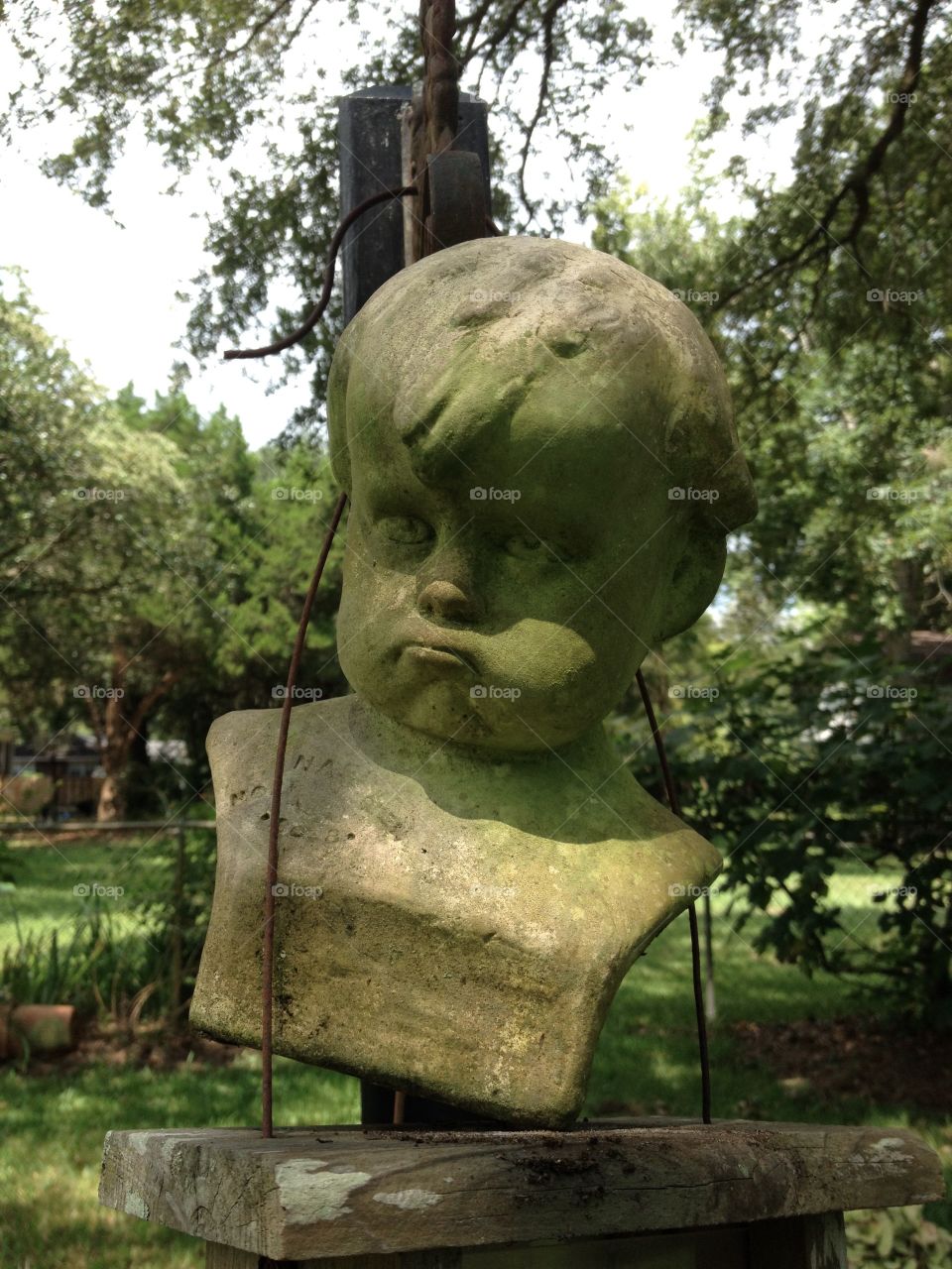 Pouting boy. Clay bust find in yard 