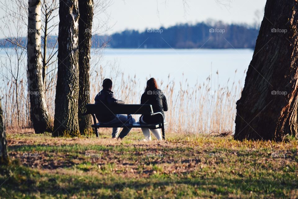 Couple sitting on a bench in spring