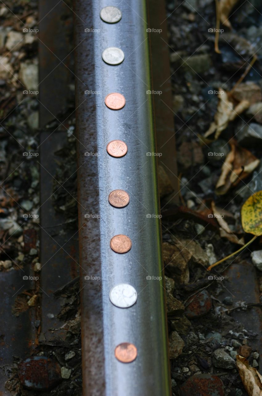 Coins on a railroad track, awaiting the next train. Coins on a railway track, childhood games