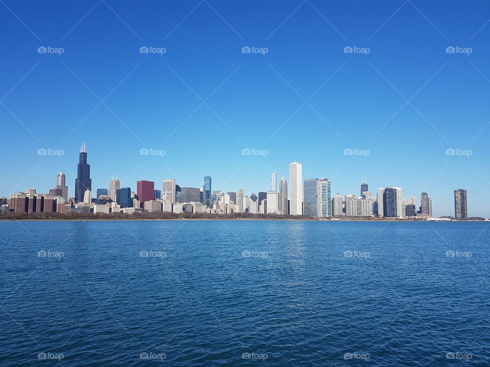 The skyline in background seems to separate the sky and the Michigan lake in foreground. Chicago. Illinois. USA.