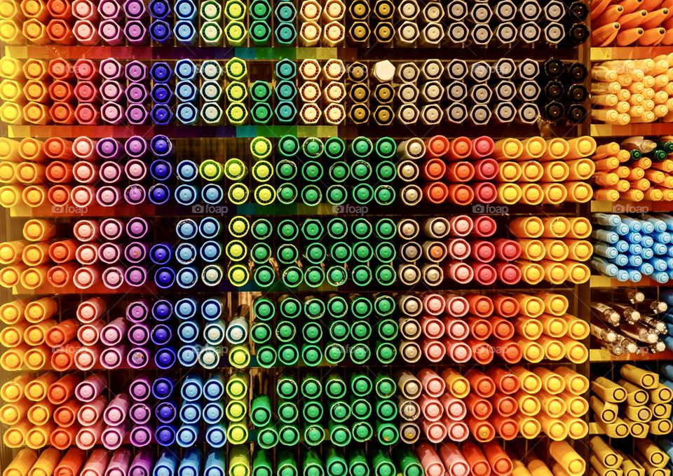 Display case of many coloured felt markers - rows of colourful pens