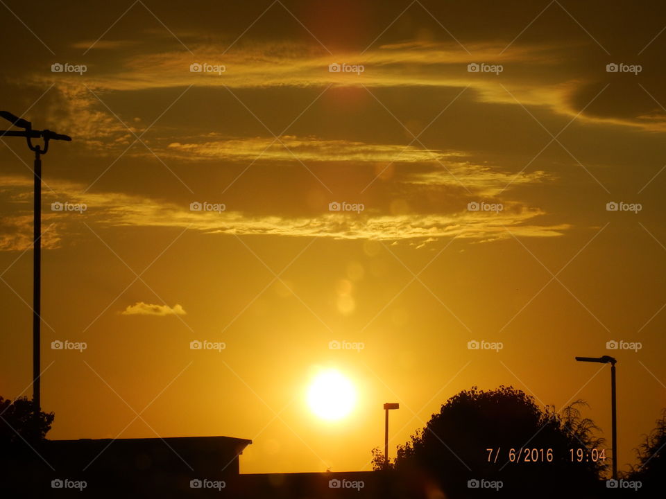 Sunset clouds, building & tree