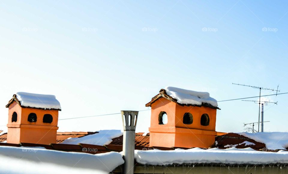 Chimneys with snow caps