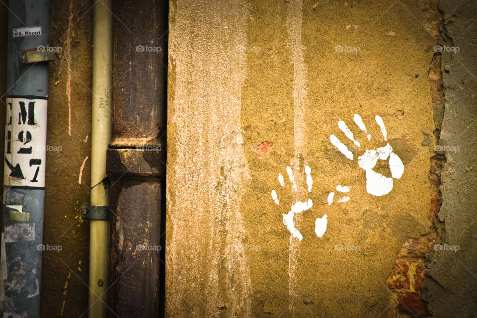 handprints on street wall