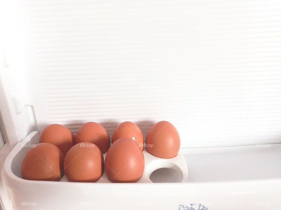 eggs on the shelf in the refrigerator