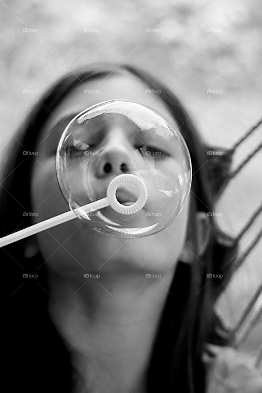 A boy blowing soap bubble 