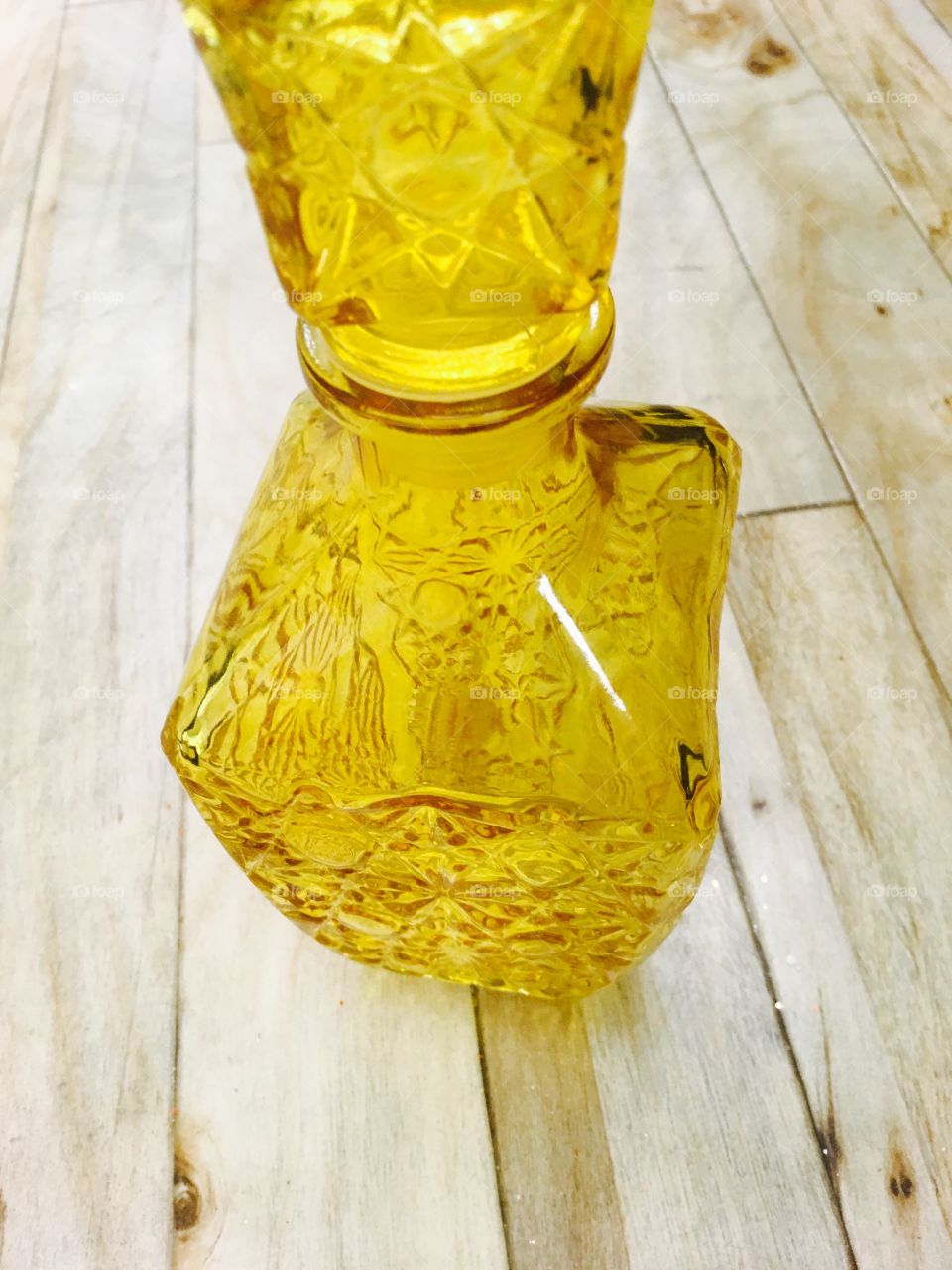 This capture is a representation of a yellow glass bottle.