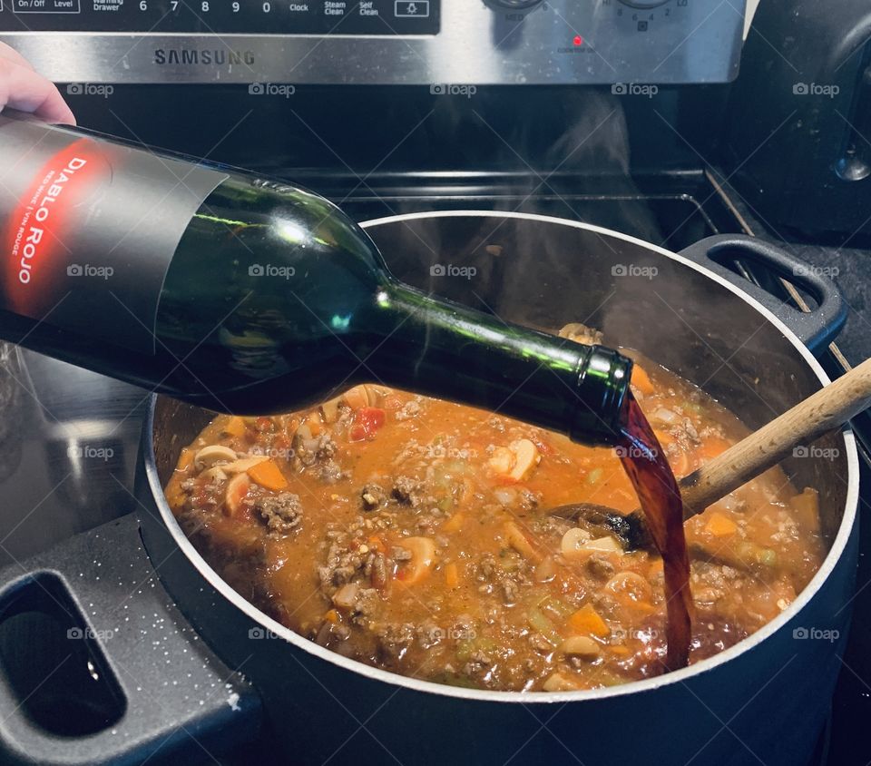 Adding wine to the sauce 