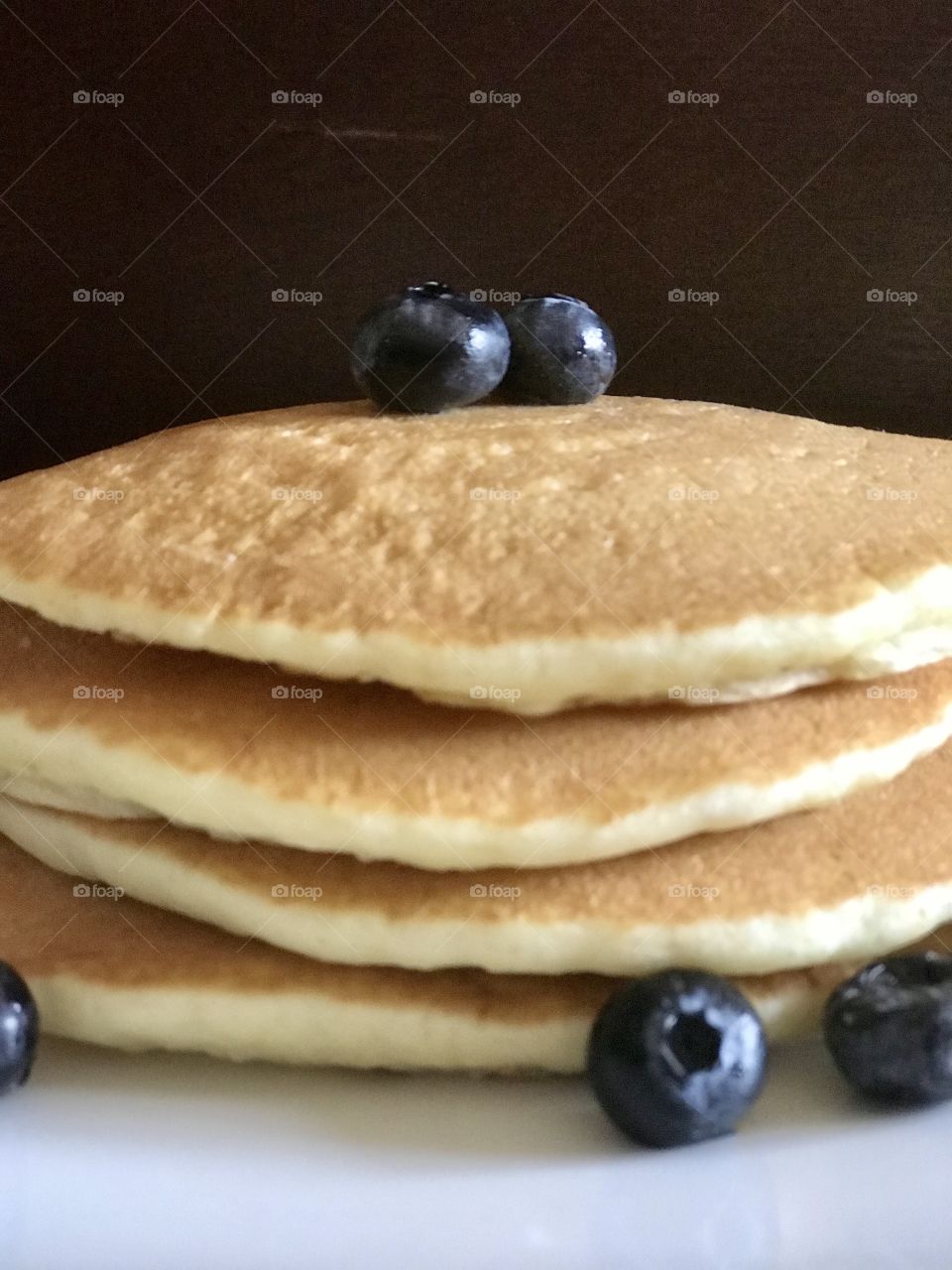 Stack of golden griddle hot cakes - pancakes with blueberries 