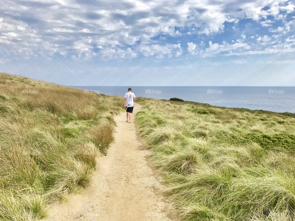 Walking along a track towards the beach