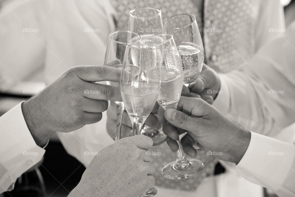 People holding glasses of champagne making a toast