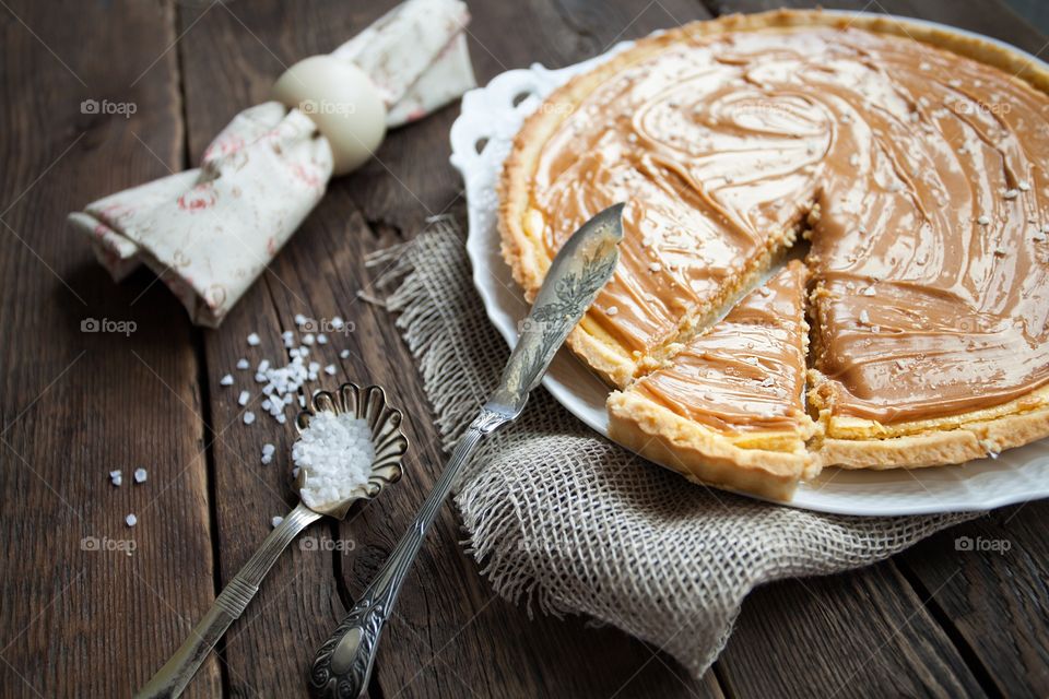 Caramel tart on wooden table