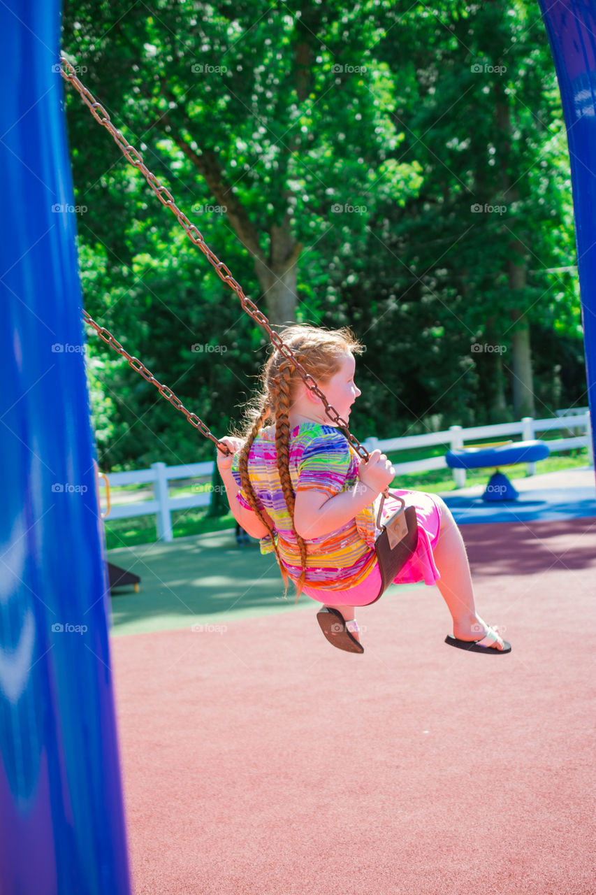 Young Girl Swinging at a Playground 2