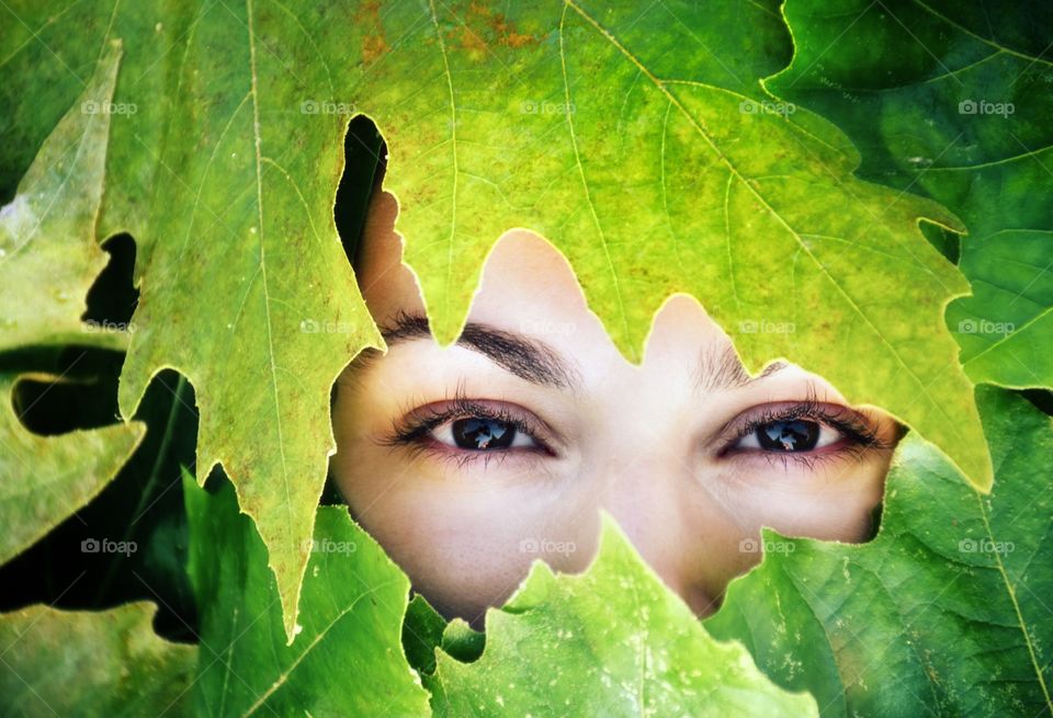 Woman eyes surrounded with autumn leaf
