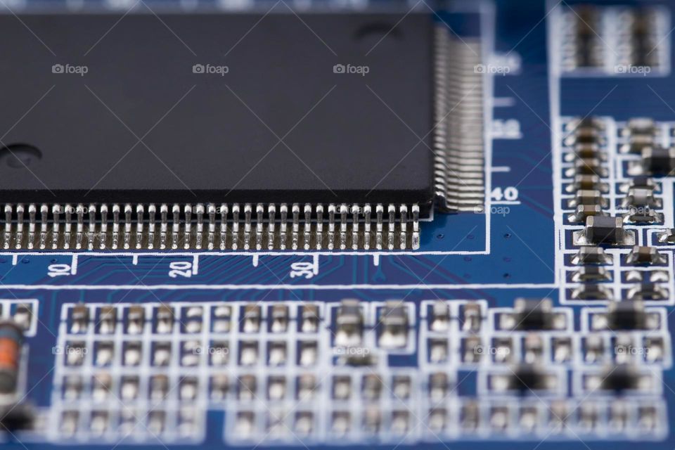 black microchip on  on blue printed circuit board. Abstract technology black background.