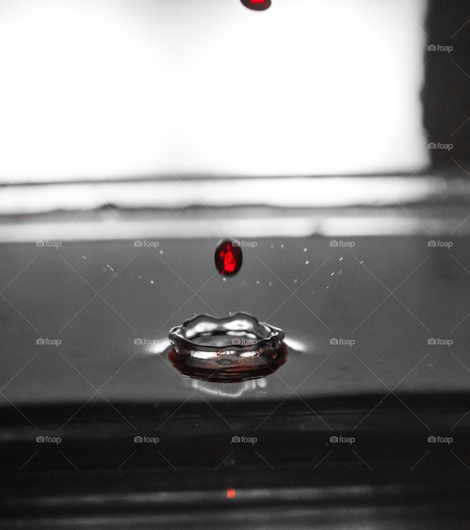 A drop of human blood flows into the water.
