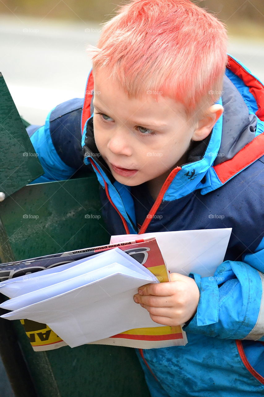 Boy getting letters from the mailbox