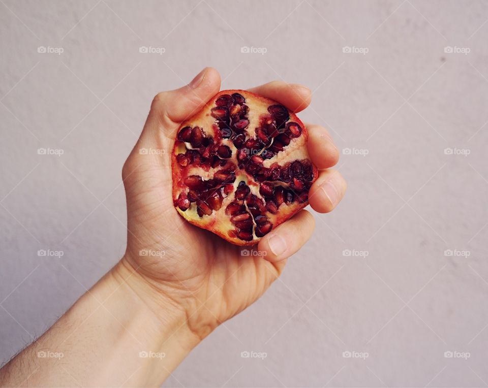 Hand holding pomegranate 