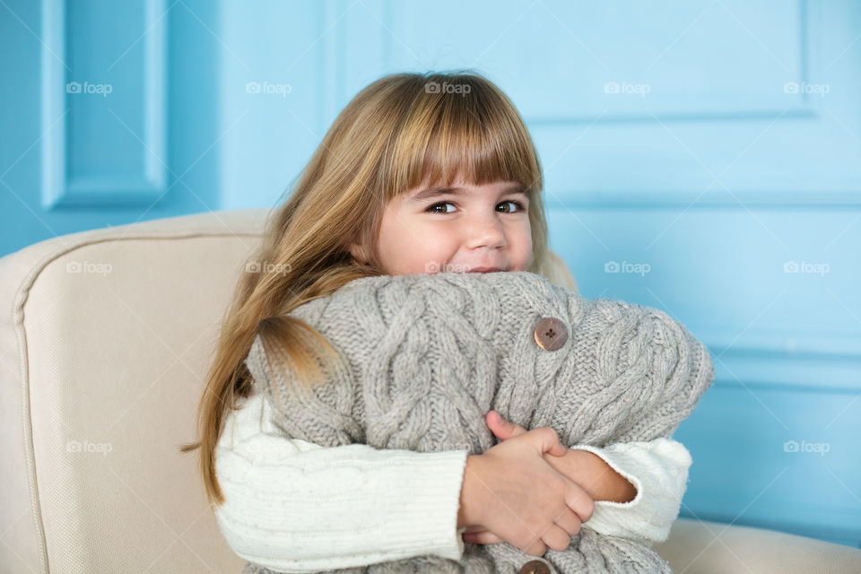 Portrait of girl holding warm clothe