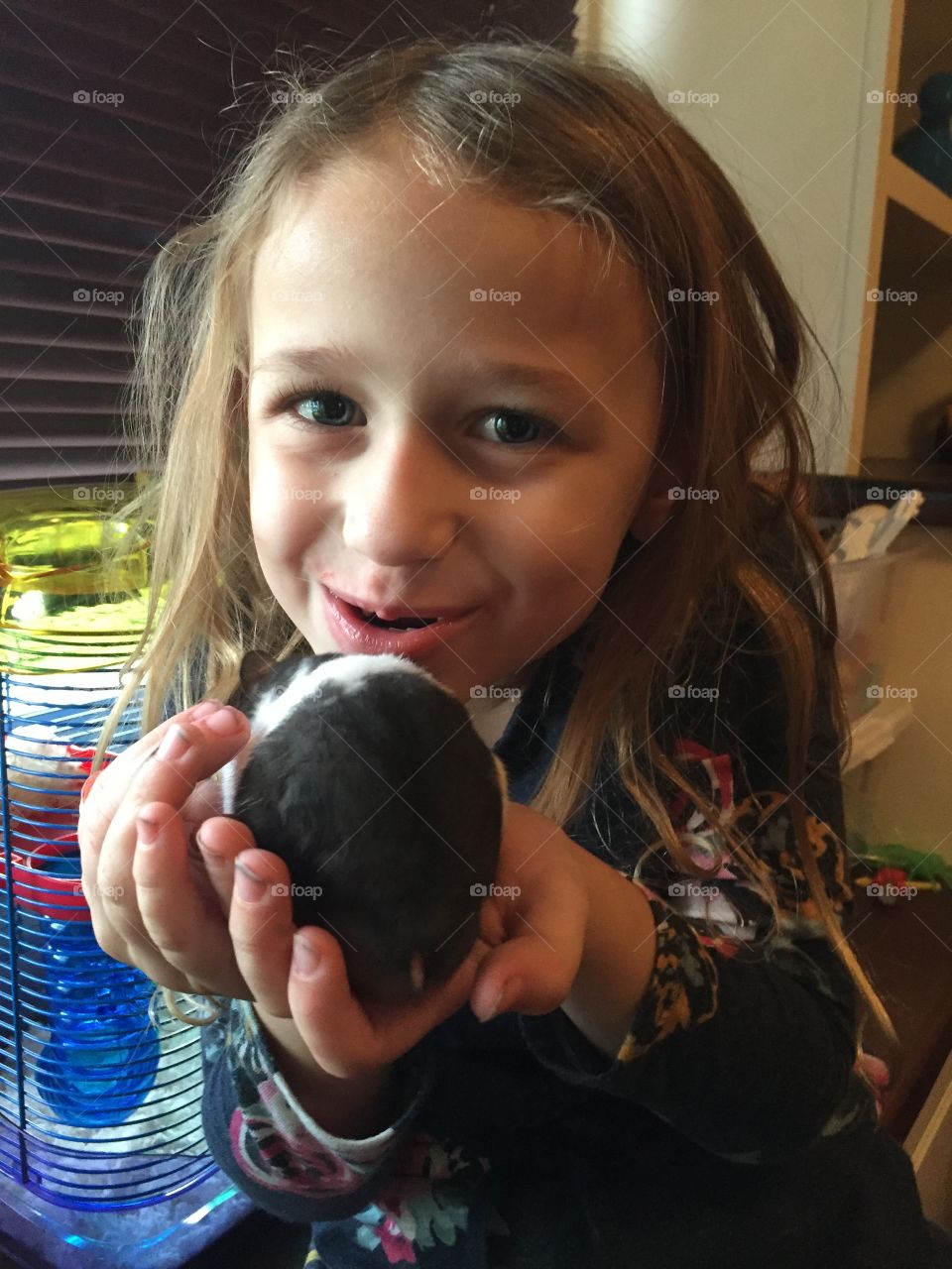 Portrait of a pretty girl holding pet in hand