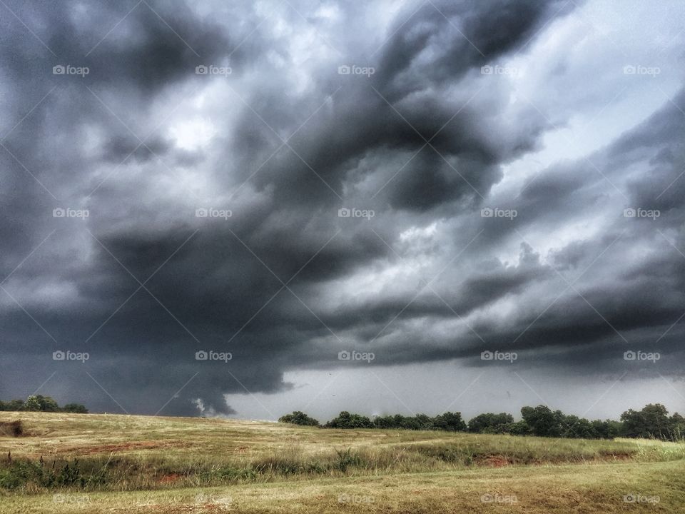 Storm rolls over a rural farm field
