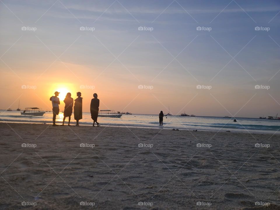 Silhouettes of people on the beach in Zanzibar
