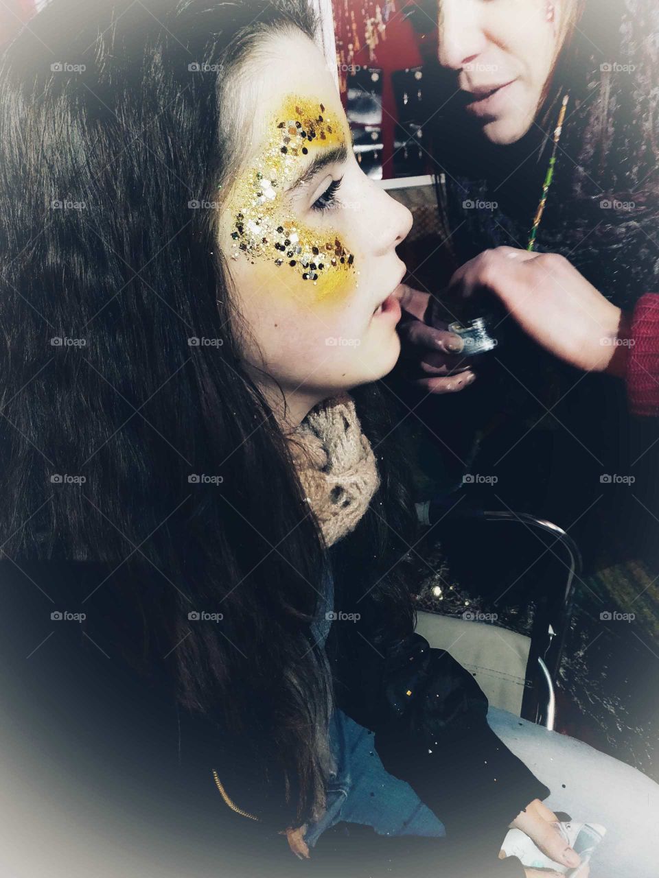 Girl being face painted.