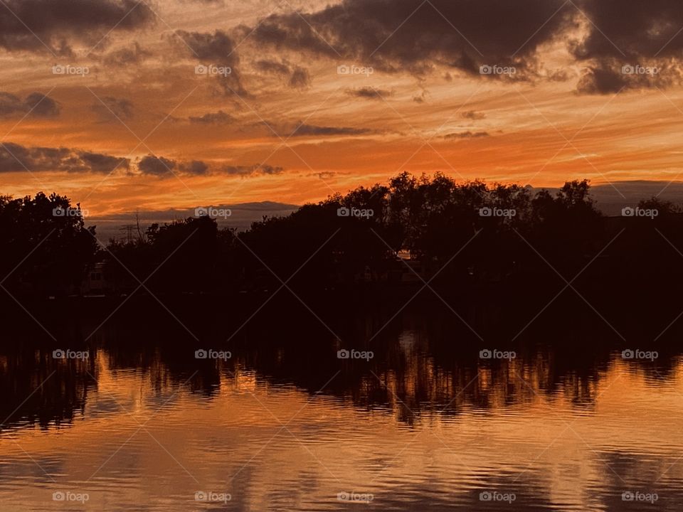 Another beautiful evening with the over head clouds forming a massive Reflection of the smooth wAters of the Lake at Sunset. 