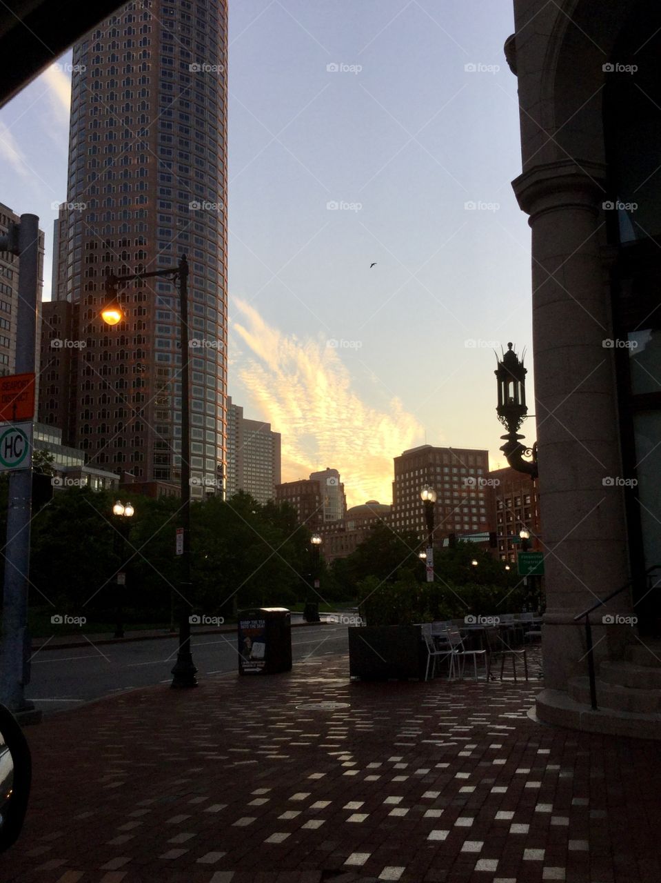 Watching the sunrise between buildings in the city