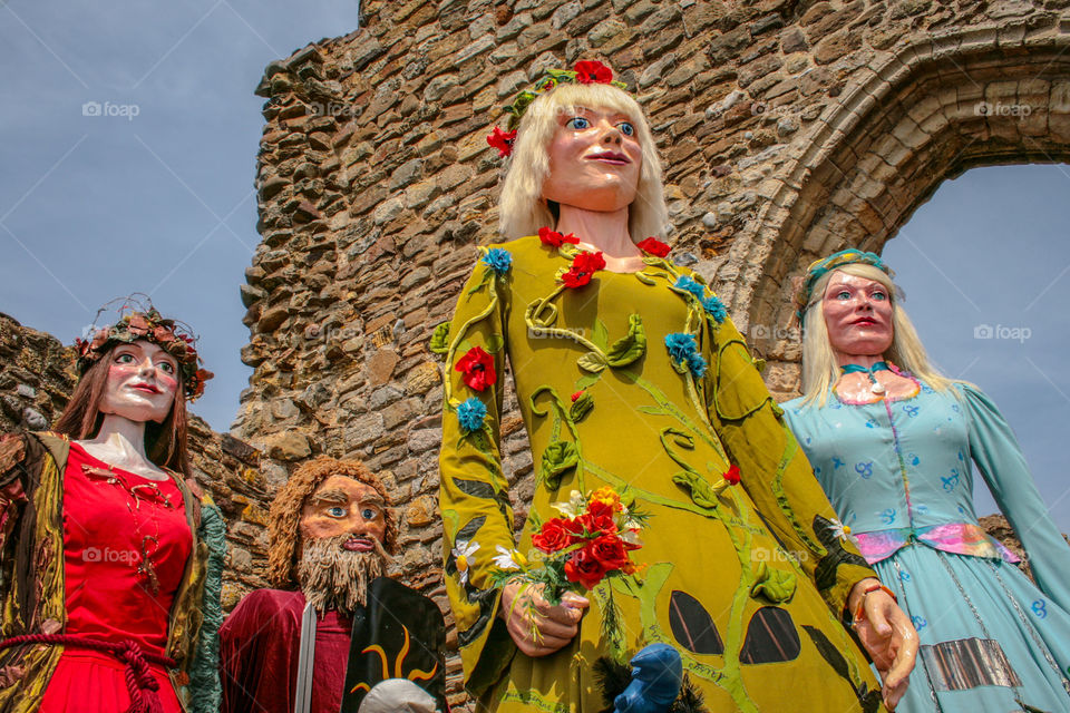 Four papier-mâché giants against the castle wall at Hastings Traditional Jack in the Green, U.K. 2008