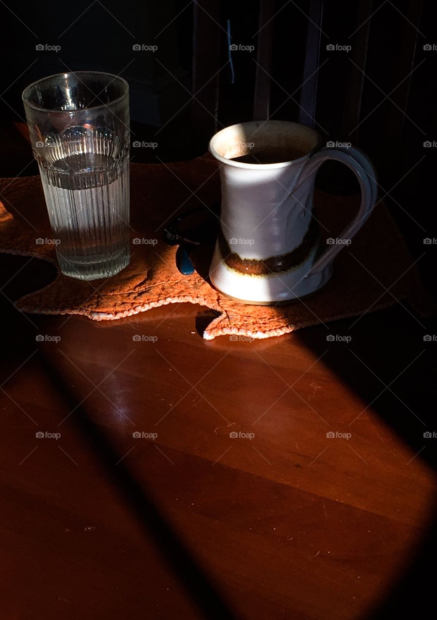 Morning light traveling across the kitchen table.  Lights and shadows highlighted. 