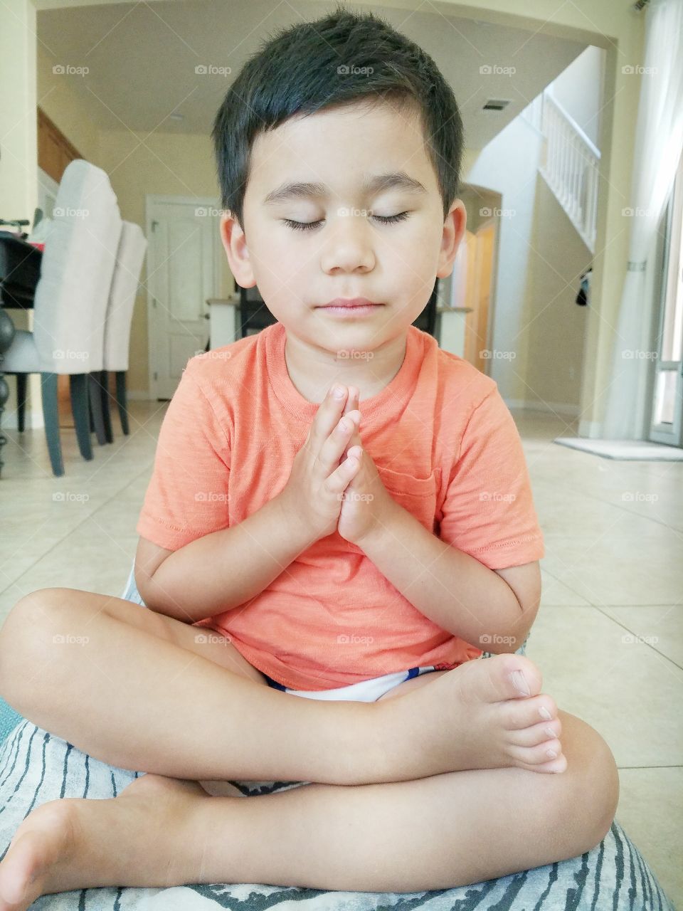 Portrait of a young boy meditating