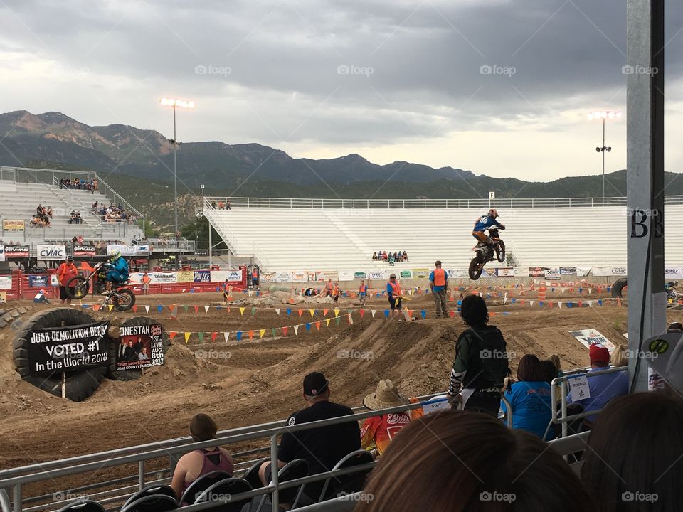 Extreme dirt biking competition featuring a rider mid-air 