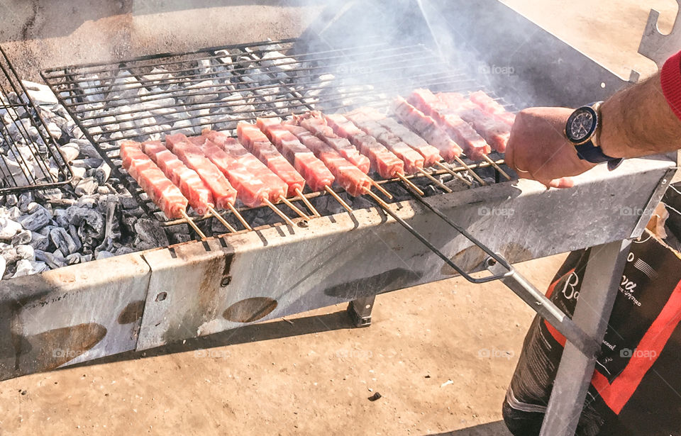 Man Roasting Barbecue On Grill Greek Souvlakia Pork Meat
