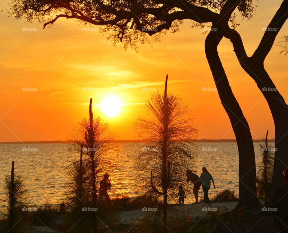 Silhouette of woman and child enjoying during sunset