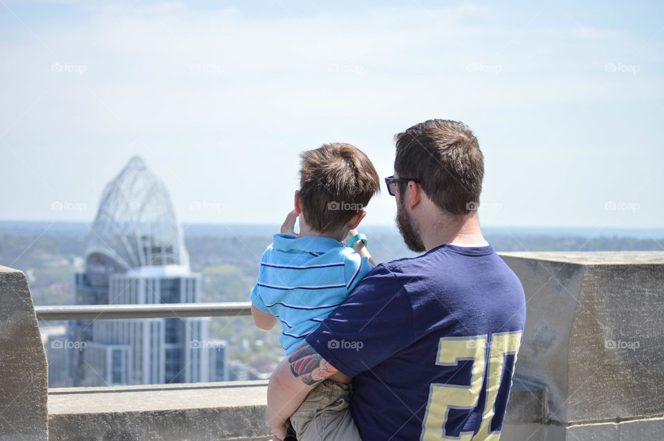 Father and son looking out over Cincinnati skyline