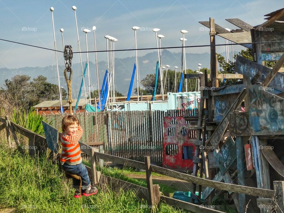 Joyful Boy Riding A Zip Line. Child In Motion
